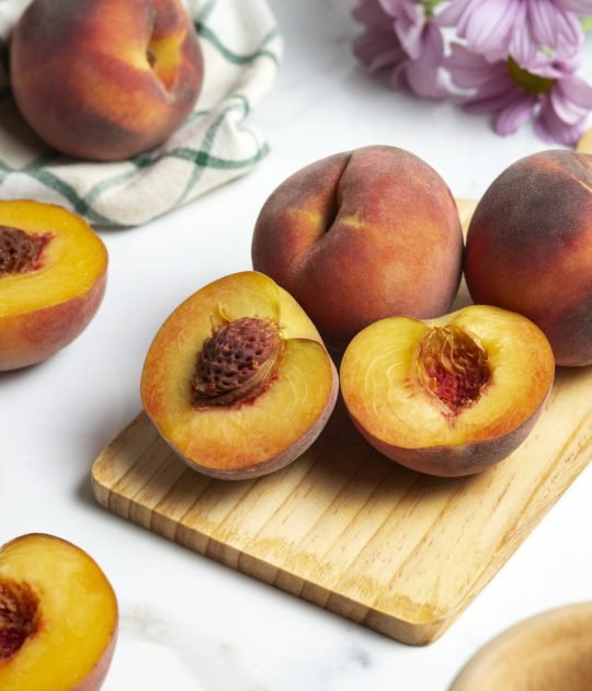 high-angle-peaches-wooden-board